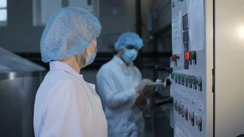 Engineer talks to colleague checking equipment at plant 스톡 동영상 145813654