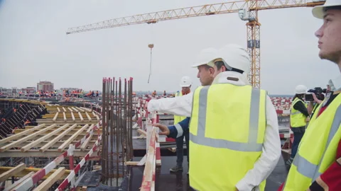 Engineer talks to taskmaster standing on stadium tribune Stock Footage 228227156
