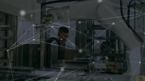 Engineer tapping tablet and initiating digital network linking machines across Video stock 329500163