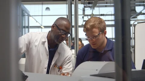Engineer Teaching Apprentice How To Use Machine In Factory Stock Footage 86600731
