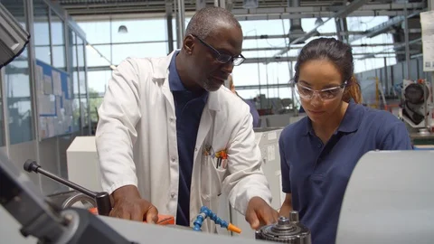 Engineer Teaching Apprentice How To Use Machine In Factory Stock Footage 86600767
