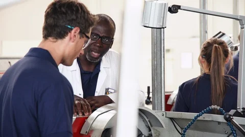 Engineer Teaching Apprentice How To Use Machine In Factory Video stock 86602051