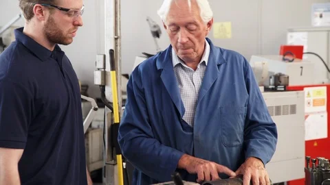 Engineer Teaching Apprentice How To Use Machine In Factory Stock Footage 86602062