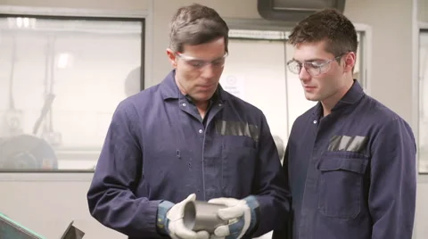 Engineer Teaching Apprentice To Use Grinding Machine Video stock 40430208