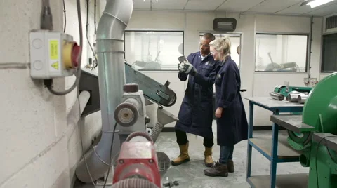 Engineer Teaching Apprentice To Use Grinding Machine Stock Footage 40430229