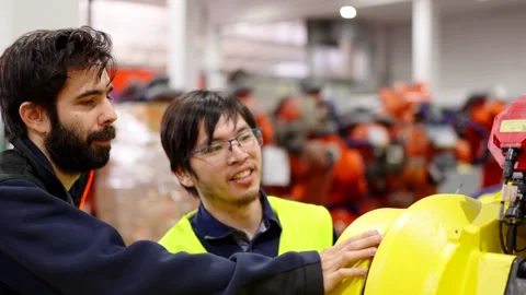 Engineer teaching the job to employee Stock Footage 260095351
