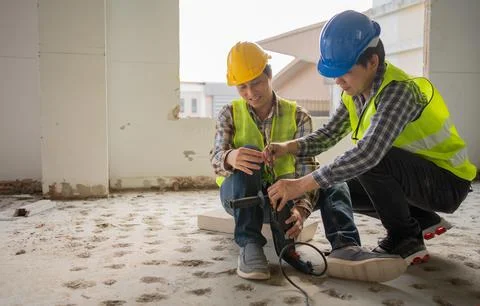 Engineer teaching worker for use electric jackhammer for perforator equipment Stock Photos