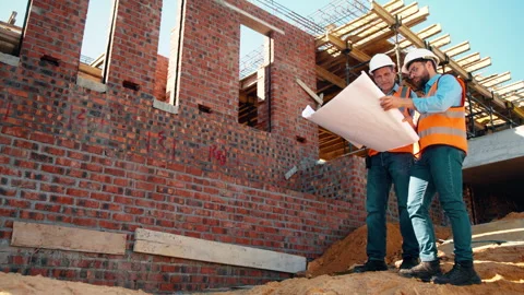Engineer, team and blueprint on construction site with discussion, collaboration Stock Footage 336219462