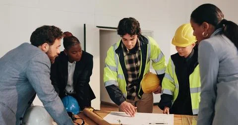 Engineer, team and discussion on site with blueprint, review project timeline or Stock Photos