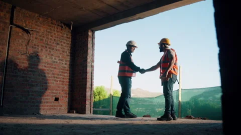 Engineer, team and handshake on construction site with collaboration, deal and Stock Footage 336220837