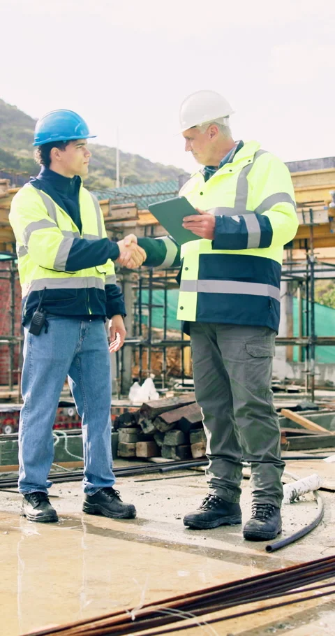 Engineer, team and handshake on construction site with tablet, property planning Stock Footage 340899622