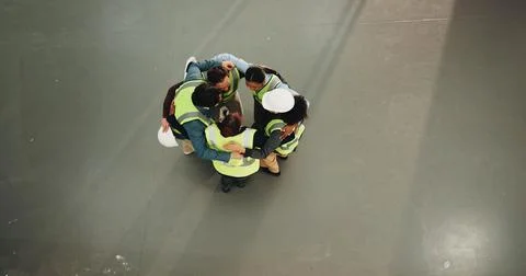 Engineer, team and huddle at worksite for collaboration, project management and Stock Photos