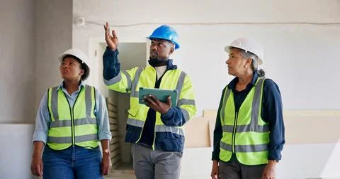 Engineer, team and talk at building site with tablet, inspection or technic.. Stock Photos