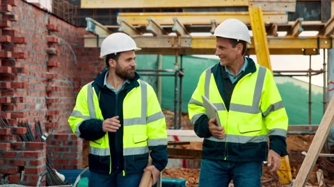 Engineer, team and walk with men on construction site for property developer Stock Footage 336202918