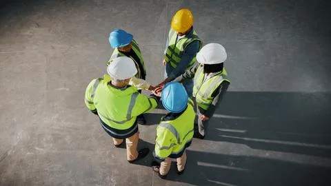 Engineer, team building or stack hands at construction site for support Stock Photos