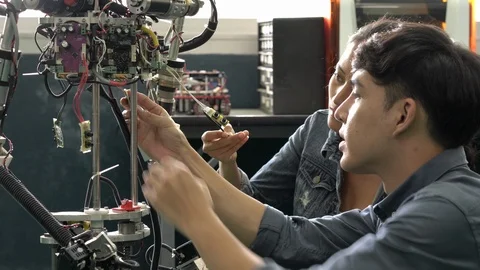 Engineer team collaborating development robot in modern laboratory. Stock Footage 113005787