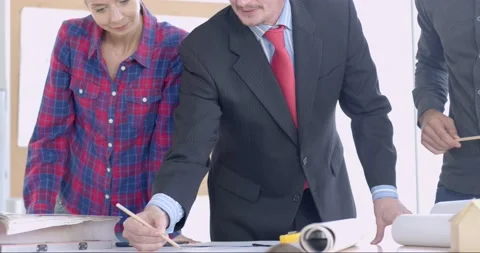 Engineer team discussing with manager or boss and working on table Stock Footage 143956131