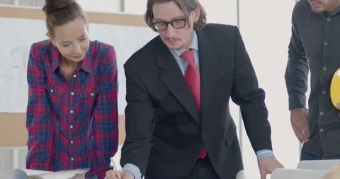 Engineer team discussing with manager or boss and working on table Stock Footage 146025876