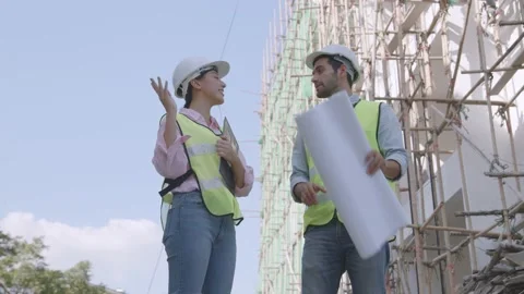 Engineer team planning and looking on blue print in construction site Stock Footage 150564208