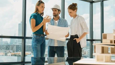 Engineer team talk about design while manager hold at project plan. Tracery Stock Photos