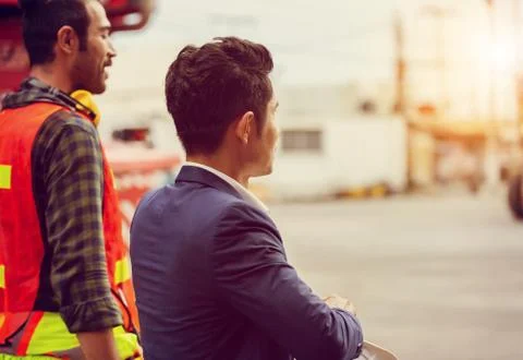 Engineer team together talking with foreman worker and walking in the cargo c Fotos de archivo