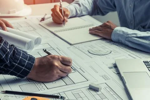 Engineer team working in office with blue prints.Team of architects people. Stock Photos