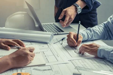 Engineer team working in office with blue prints.Team of architects people. Stock Photos