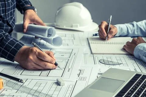 Engineer team working in office with blue prints.Team of architects people. Stock Photos