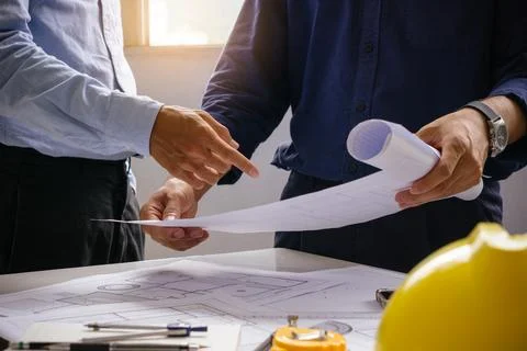 Engineer team working in office with blue prints.Team of architects people. Stock Photos