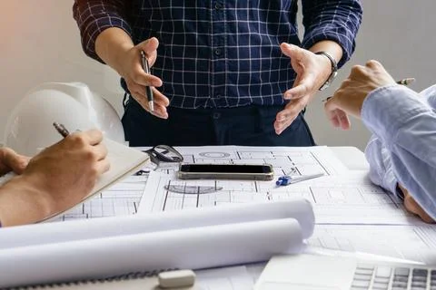 Engineer team working in office with blue prints.Team of architects people. Stock Photos