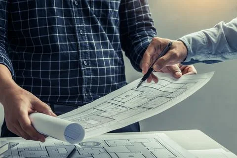 Engineer team working in office with blue prints.Team of architects people. Stock Photos