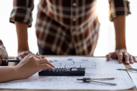 Engineer team working in the office, engineer and architect use calculator for Stock Photos