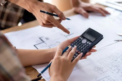 Engineer team working in the office, engineer and architect use calculator for Stock Photos