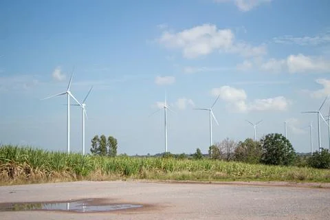 Engineer team working in wind turbine farm. Renewable energy with wind genera Stock Photos
