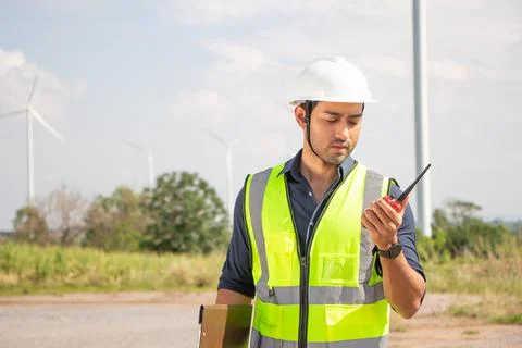 Engineer team working in wind turbine farm. Renewable energy with wind genera Stock Photos