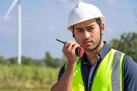 Engineer team working in wind turbine farm. Renewable energy with wind genera Stock Photos