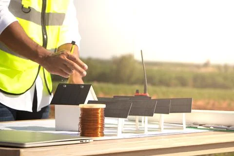Engineer team working in wind turbine farm and solar cell. Renewable energy with Stock Photos