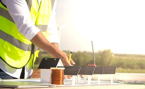 Engineer team working in wind turbine farm and solar cell. Renewable energy with Stock Photos