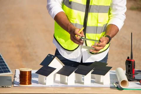 Engineer team working in wind turbine farm and solar cell. Renewable energy with Stock Photos