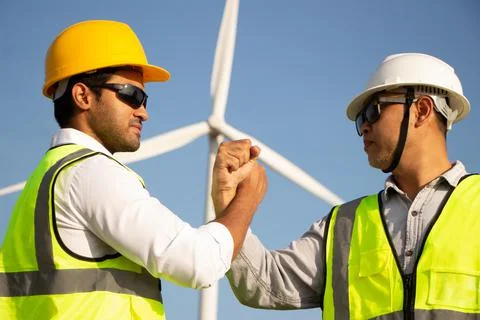 Engineer team working in wind turbine farm. Renewable energy with wind genera 스톡 사진