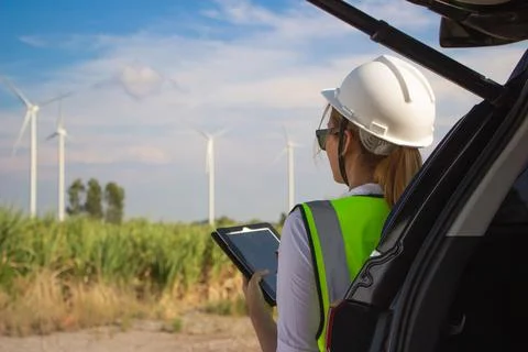 Engineer team working in wind turbine farm. Renewable energy with wind genera Stock Photos