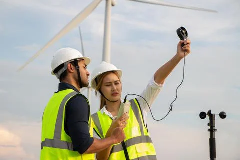 Engineer team working in wind turbine farm. Renewable energy with wind genera 스톡 사진