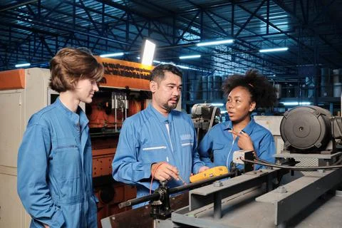 Engineer teams inspect machines' electric current at the industry factory Stock Photos