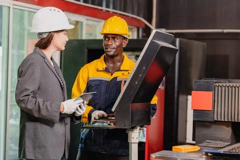 Engineer teamwork, Worker man and woman team working together in metal work.. Stock Photos