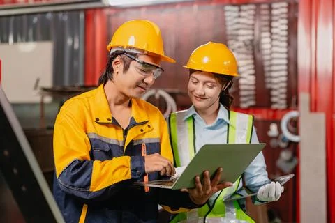 Engineer teamwork, Workers man and woman team working together in metal wor.. Stock Photos