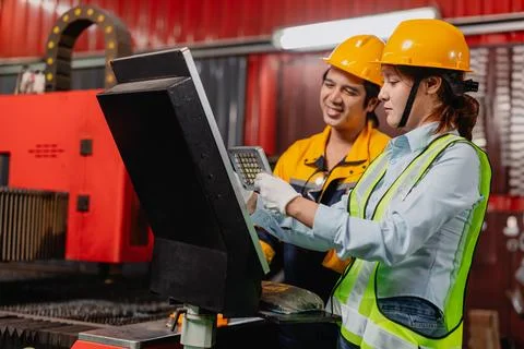 Engineer teamwork, Workers man and woman team working together in metal wor.. Stock Photos