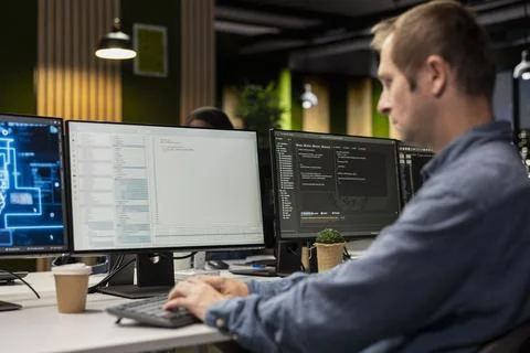Engineer in tech startup office automating repetitive tasks using AI scripts on 库存照片