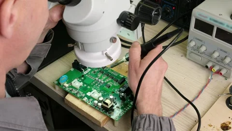 Engineer Technician adjusts the microscope to work. Stock Footage 246521253