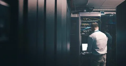 Engineer, technician and laptop with man in server room for hosting database 스톡 사진