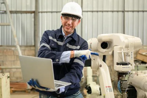 Engineer technician controlling robotic arms on computer laptop 스톡 사진